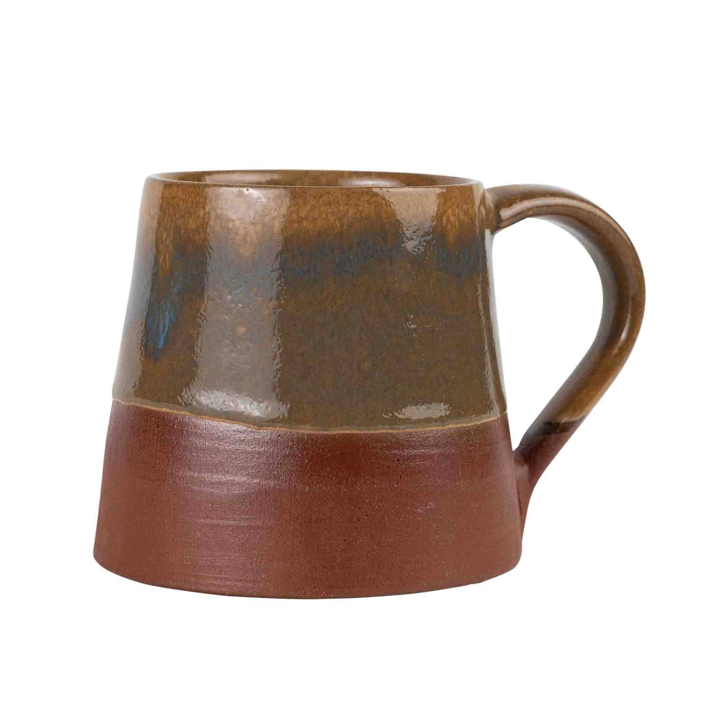 Front-facing, fuller terracotta base visible (white bg): "Front view of hand thrown terracotta ceramic mug showing two-tone glaze and unglazed russet base, part of the Terra Cotta Harvest collection"