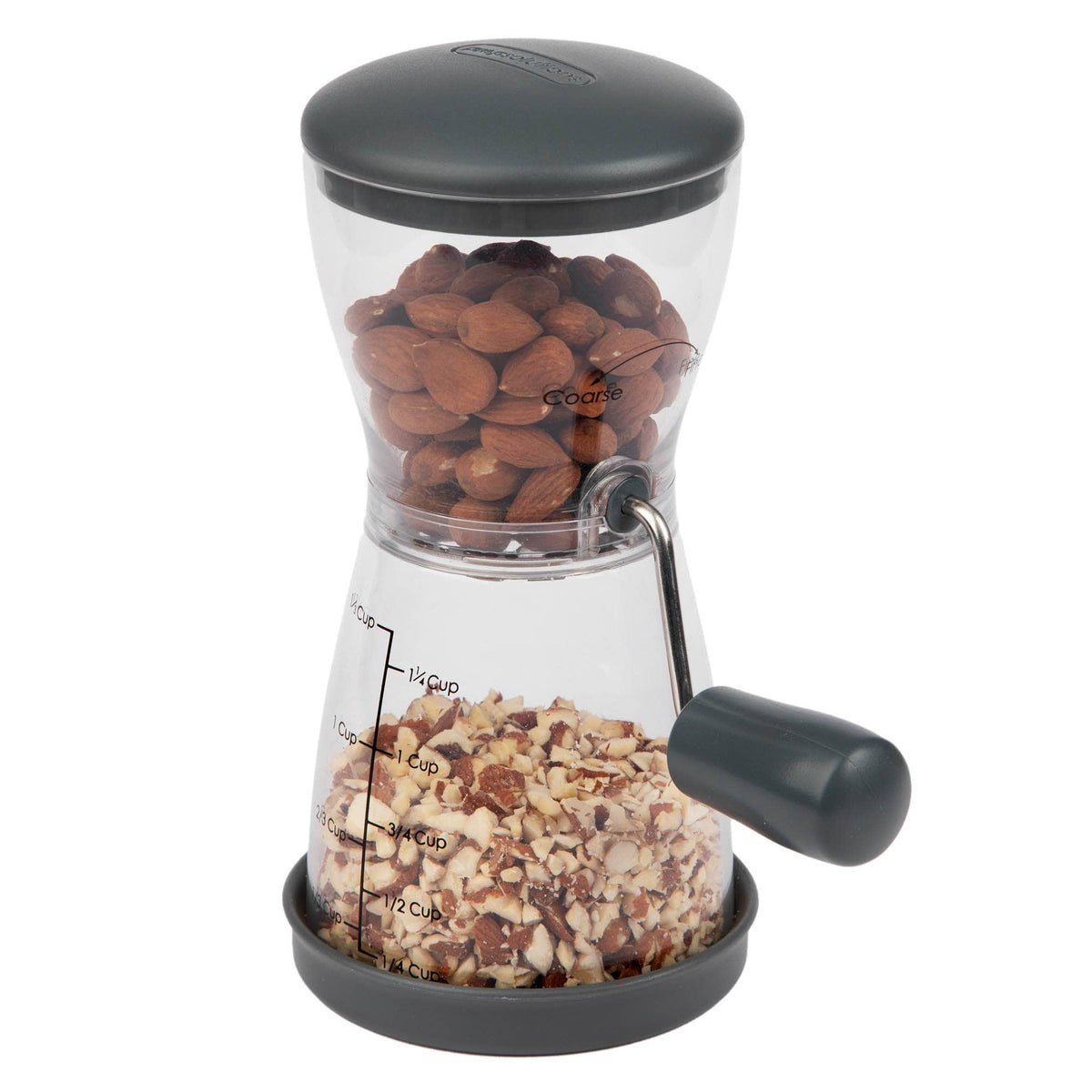 Progressive nut chopper filled with whole hazelnuts in the upper chamber and freshly chopped nuts in the lower collection chamber, shown on a white background.
