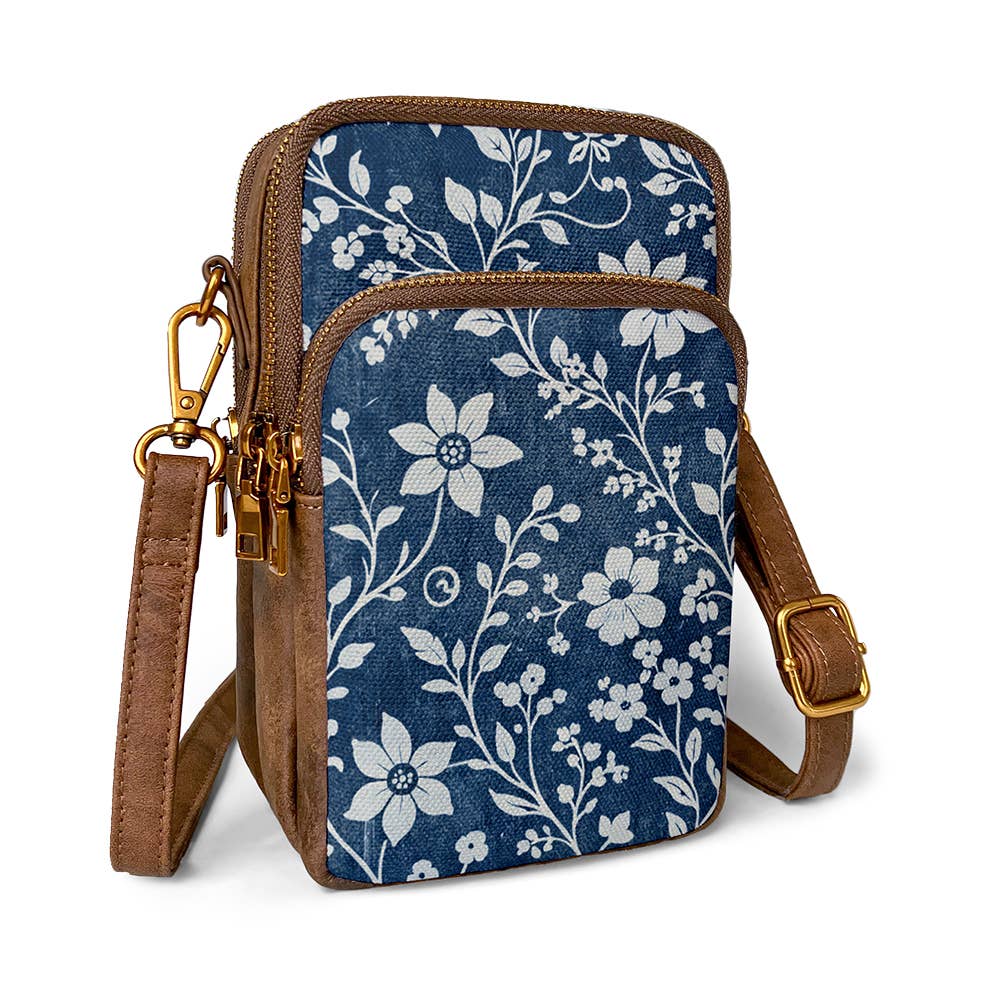 ANNGOTI Indigo Sketch Cellphone Bag — indigo canvas crossbody with white floral print, antique brass zippers, and adjustable brown PU strap"