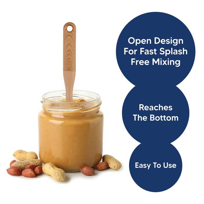 HIC Kitchen nut butter mixer standing upright in a glass jar of natural peanut butter surrounded by whole peanuts, with feature callouts: open design for fast splash-free mixing, reaches the bottom, easy to use.