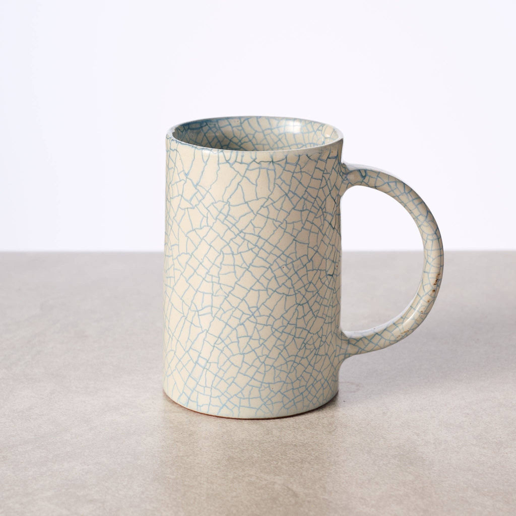 "Tall handcrafted ceramic mug with blue crackle glaze, made in Nepal by Ten Thousand Villages artisans
