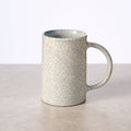 "Tall handcrafted ceramic mug with blue crackle glaze, made in Nepal by Ten Thousand Villages artisans