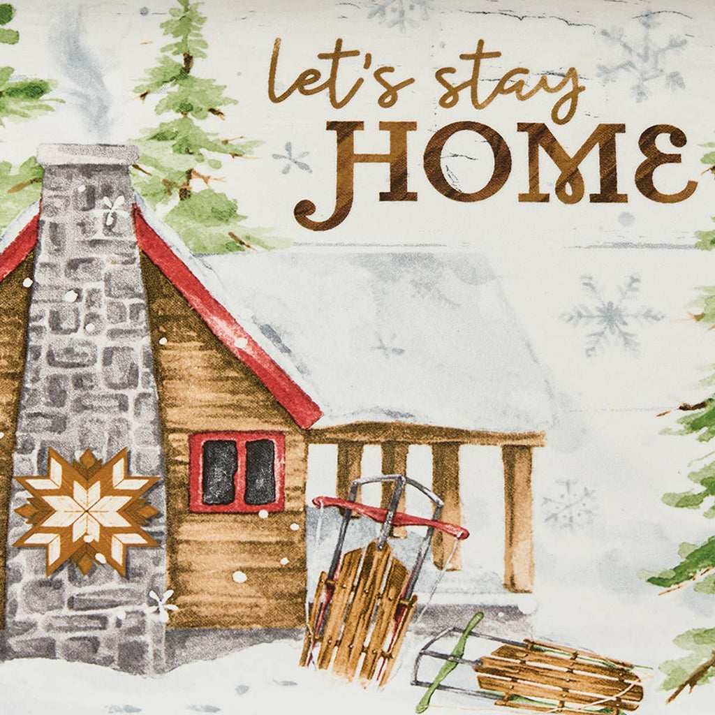 Close-up of Park Designs Snowflake Lodge platter artwork showing log cabin with stone chimney, vintage sled, and Let's Stay Home sentiment in gold