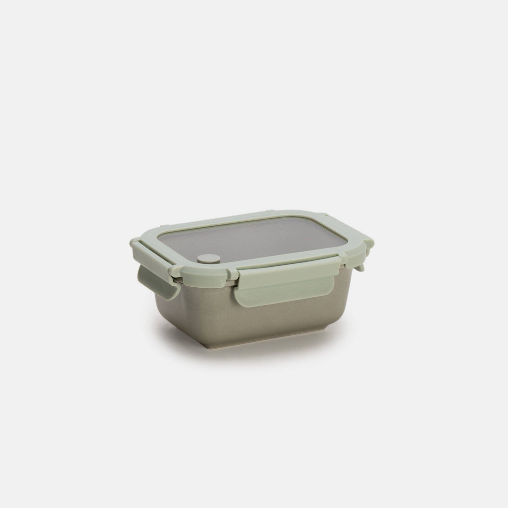 Green silicone food storage container on a white background