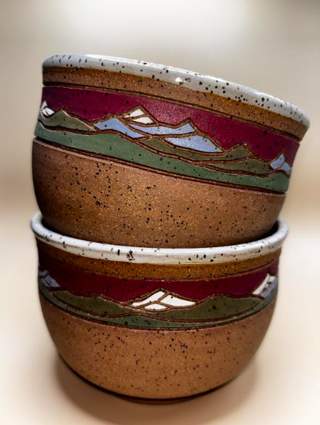 Crimson Ridge (stacked exterior shot):

"Set of 2 handmade speckled stoneware bowls with deep crimson and sage green mountain landscape band, stacked and shown from the side — Forest Jeannie Pottery"