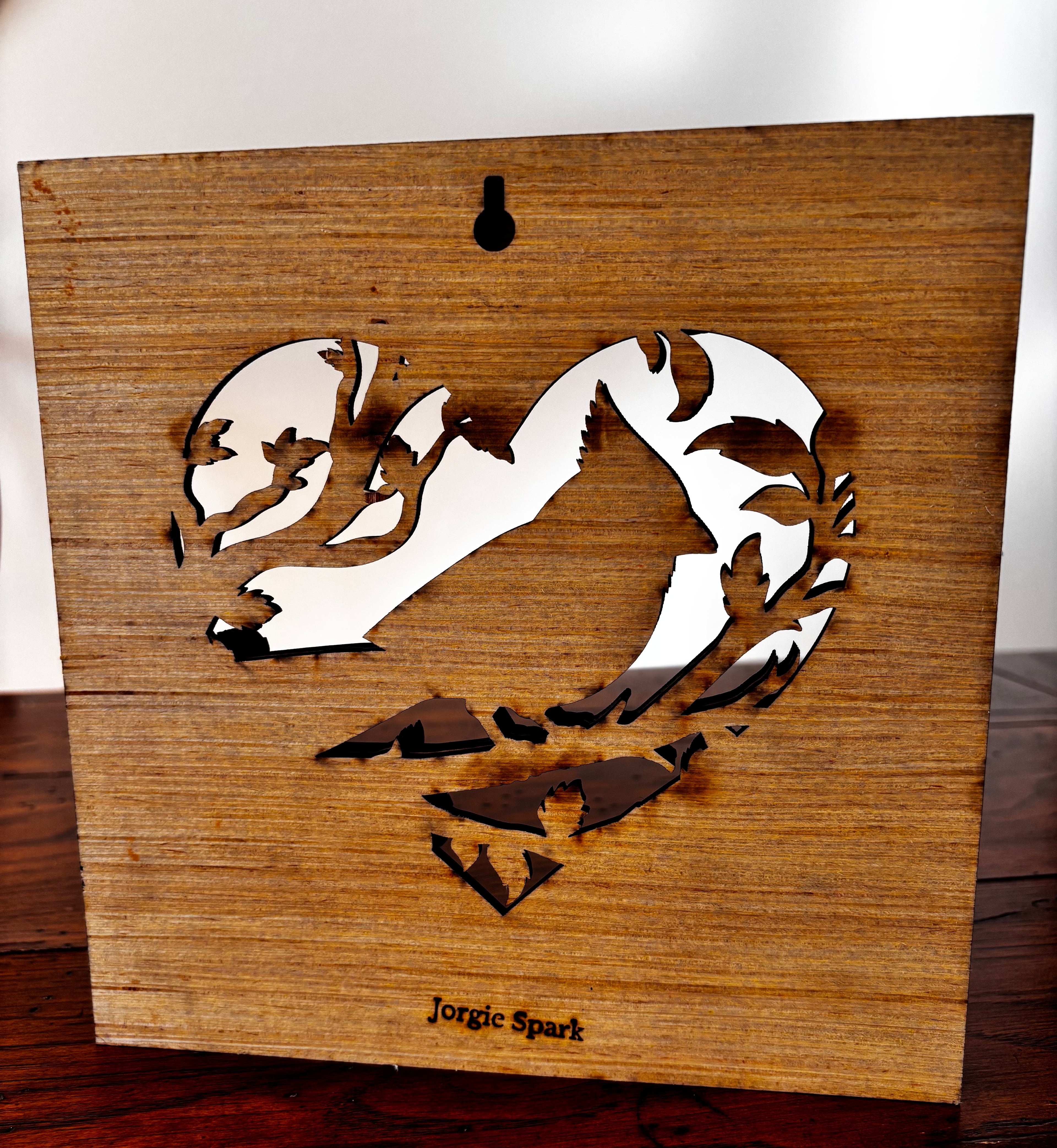 Back of the cardinal wood plaque showing the keyhole hanger, open heart design and Jorgie Spark maker’s mark.