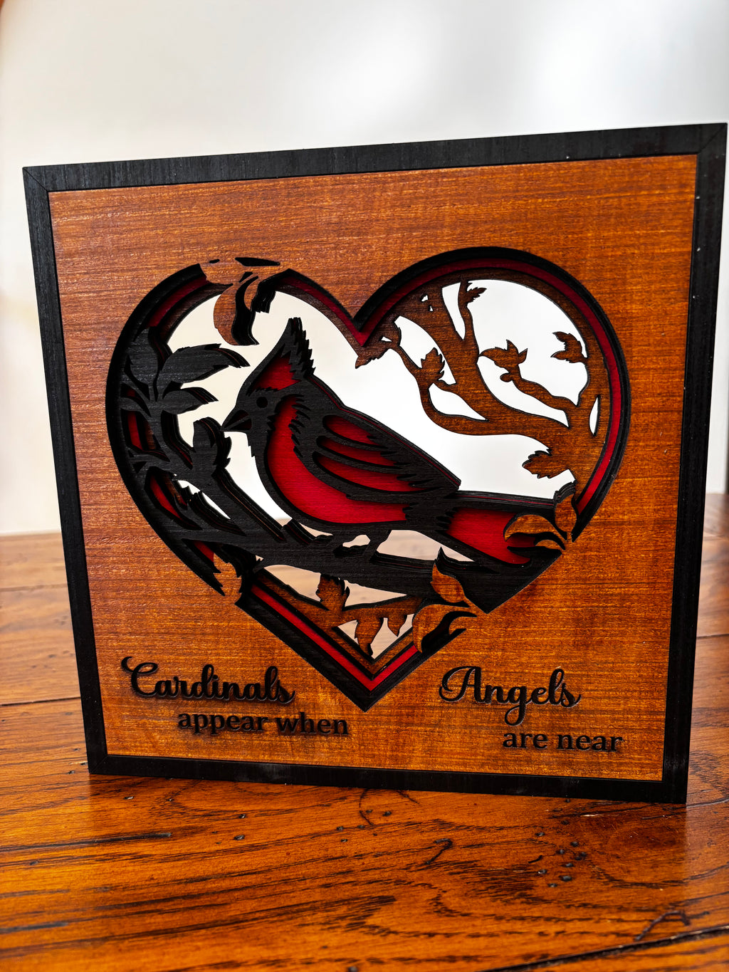 Layered wood cardinal heart plaque with red and black detailing and the message “Cardinals appear when Angels are near.”
