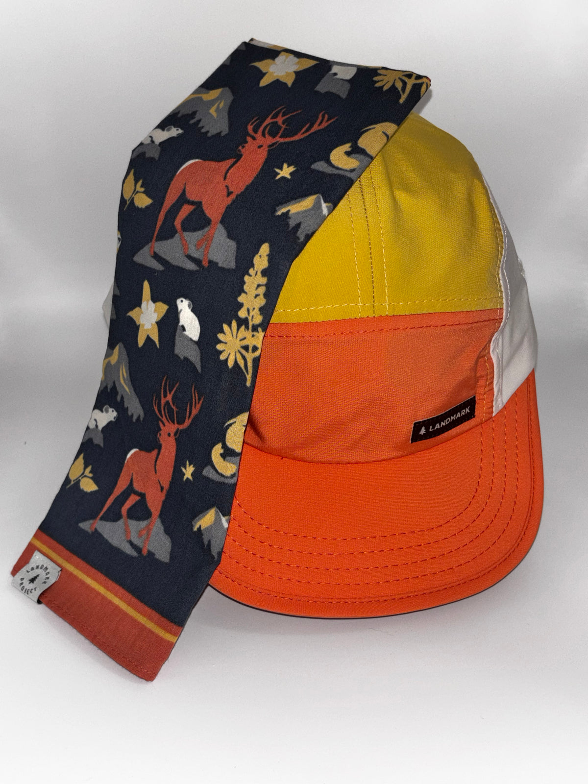 "Landmark Project Landmark Hike Hat styled with Residents of the Rockies Bandana featuring elk, bear, and mountain wildlife print on navy"