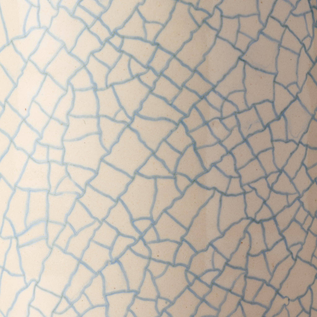 Close-up of blue crackle glaze pattern on handcrafted ceramic mug, showing intricate artisan detail"