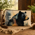 Canvas crossbody bag featuring a watercolor black bear portrait with pine trees, displayed on a burlap surface with pinecones and greenery — Anngoti