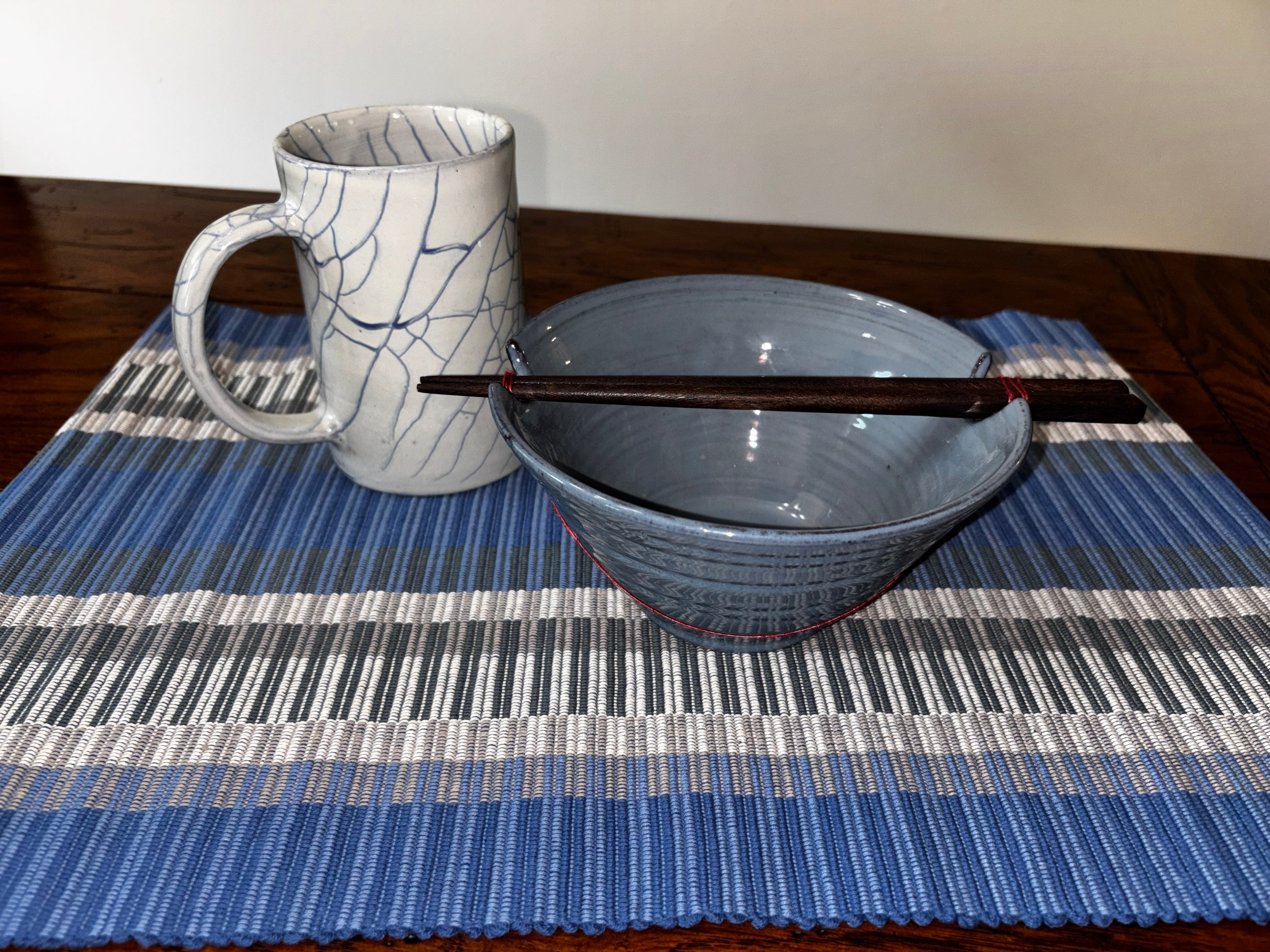 Indigo Night Ramen Set — blue crackle mug, blue stoneware bowl with chopsticks, and blue striped handloomed placemat, handcrafted in Nepal by Ten Thousand Villages
