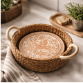 Bread basket styled shot — Korissa seagrass basket with printed cloth liner holding artisan flatbread on a wooden table with fresh herbs and olive oil