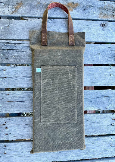 Celtic Farm waxed canvas garden kneeler showing hunter green canvas, Celtic Farm label, and leather handle detail