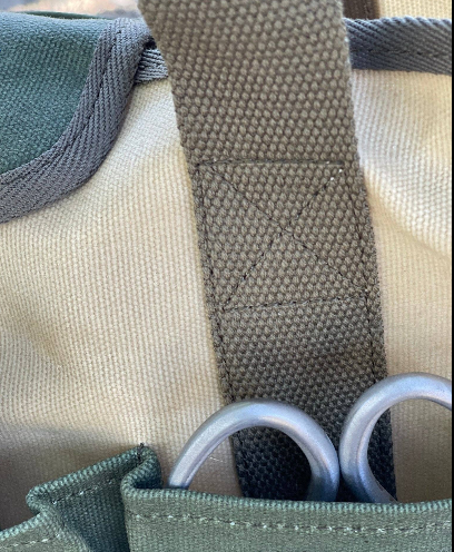 Close-up of Celtic Farm garden tote handle and strap construction showing heavy-duty canvas and metal ring hardware