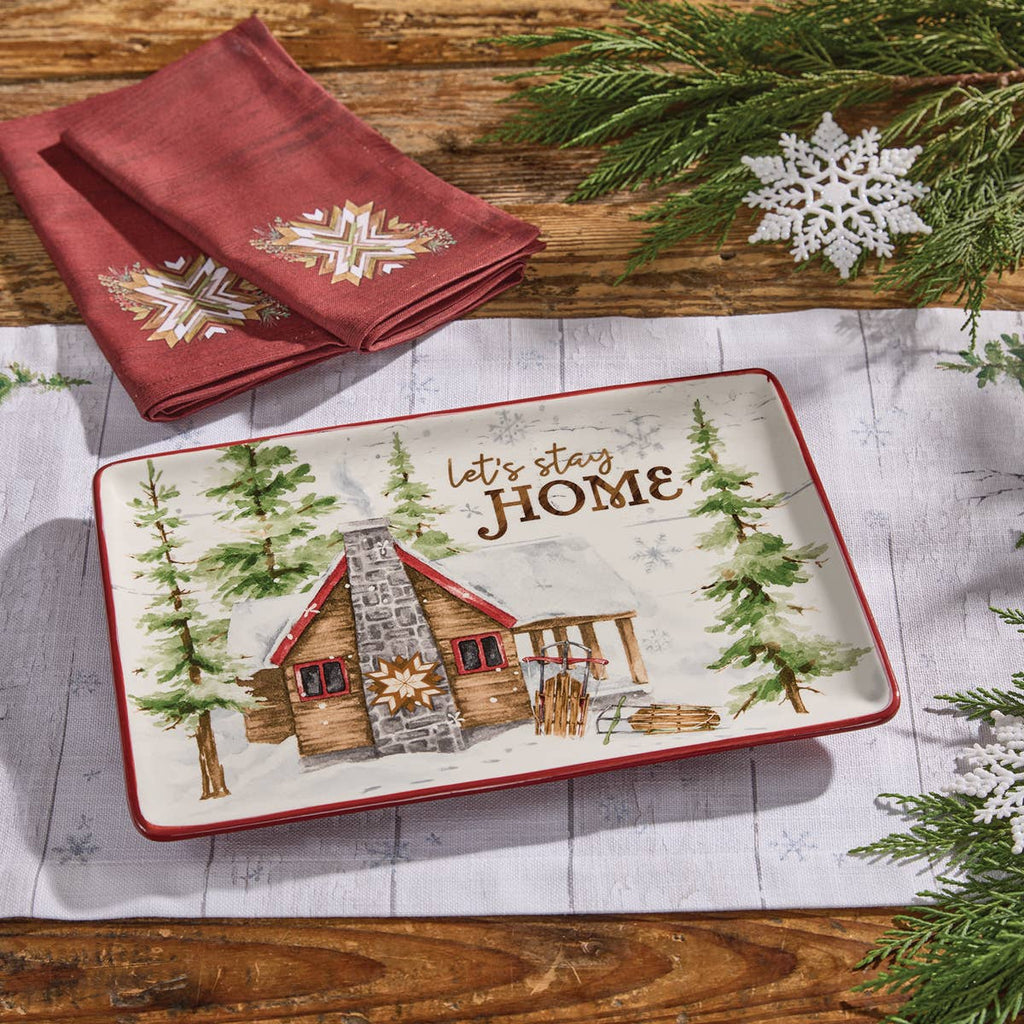 Park Designs Snowflake Lodge platter styled on a farmhouse wood table with red snowflake napkin, pine branches, and snowflake decor"