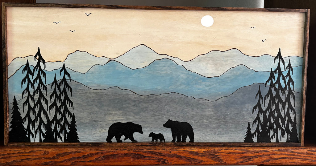Bear family framed wall art with moon and pine trees, full piece shown on wooden console table