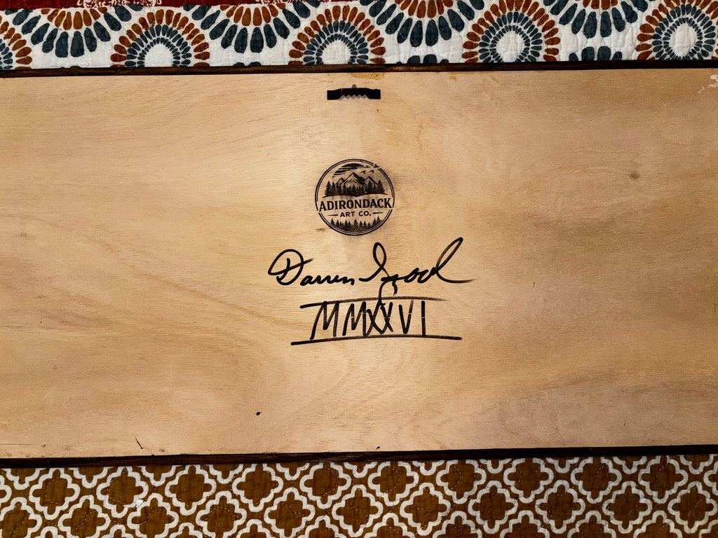Back of framed wood art showing Darren Segool's hand signature, Adirondack Art Co. brand stamp, and MMXXVI date