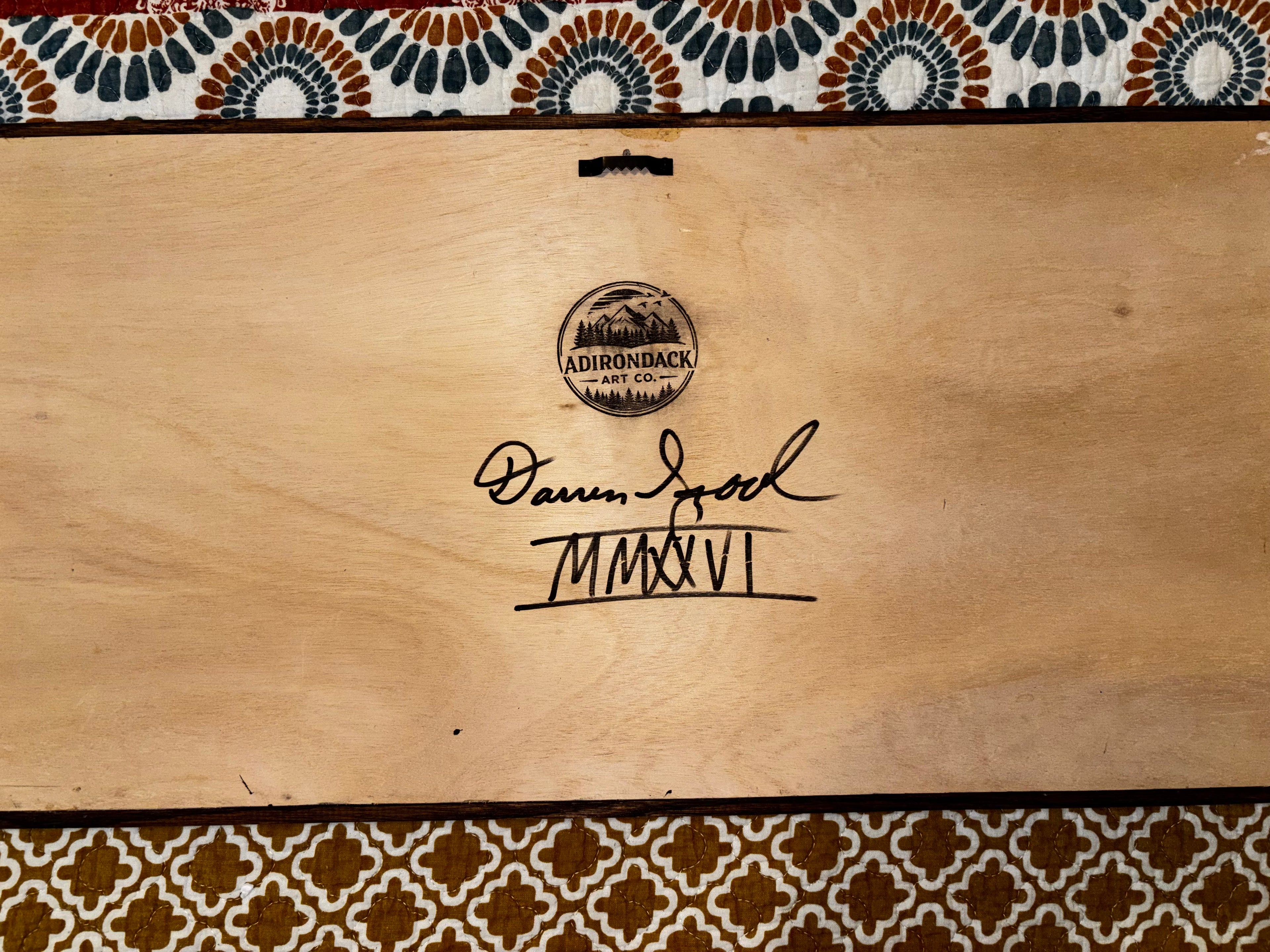 Back of framed wood art showing Darren Segool's hand signature, Adirondack Art Co. brand stamp, and MMXXVI date