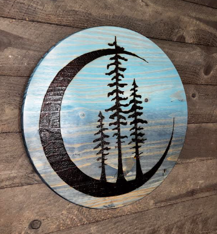 "Tres Luna handcrafted pine wall art with crescent moon and three pine trees displayed on rustic wood plank wall — Adirondack Art Co."
