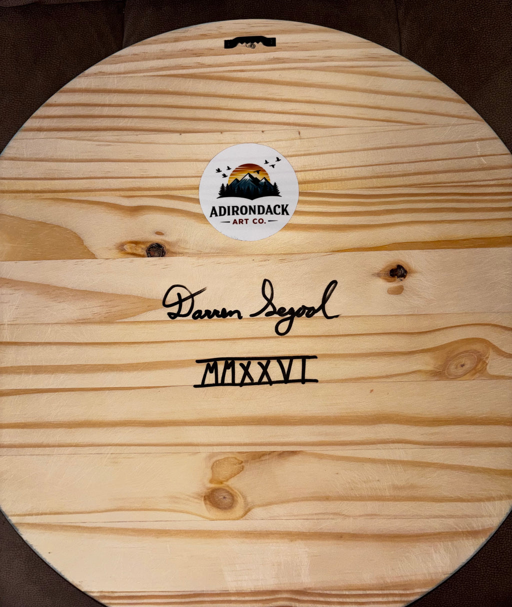"Back of Tres Luna wood wall art showing artist signature Darren Segool, year MMXXVI in Roman numerals, and Adirondack Art Co. logo sticker"