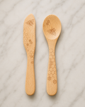 "Talisman Designs natural beechwood jam spreader and spoon set with laser-etched honey bee and honeycomb design, displayed on white marble"