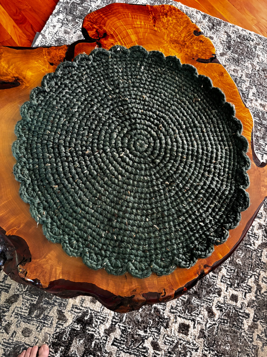 Overhead view of a deep green wool blend crochet cat lounger showing the rich earthy color and substantial handcrafted texture by Sleeping Whiskers Studio.