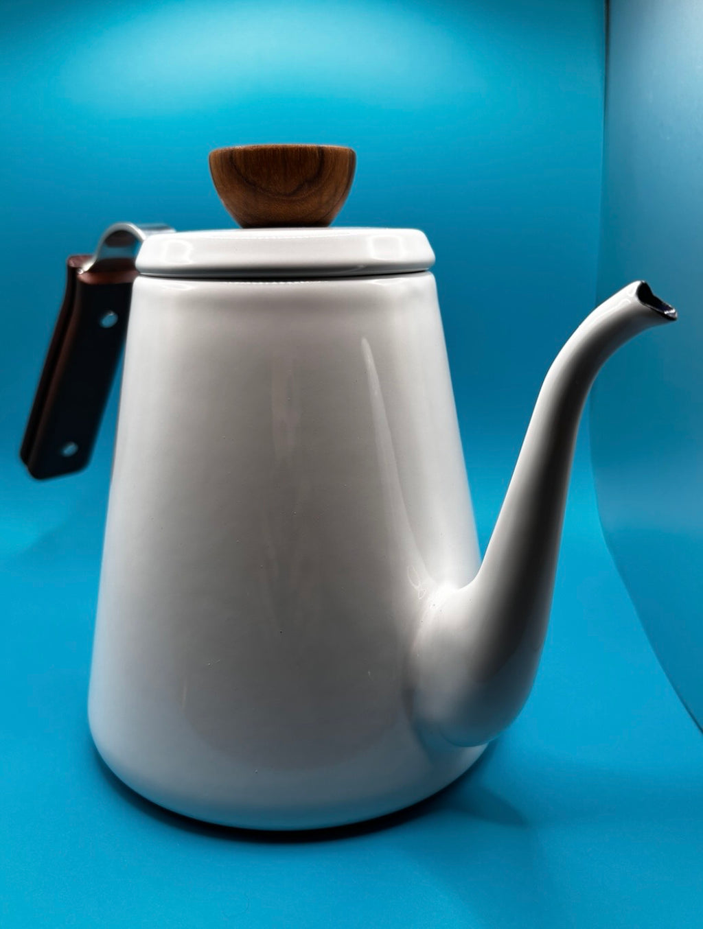 White enamel gooseneck pour over coffee kettle with walnut wood lid knob and handle, showing Bona Coffee Drip Kettle label — product shot on blue background"